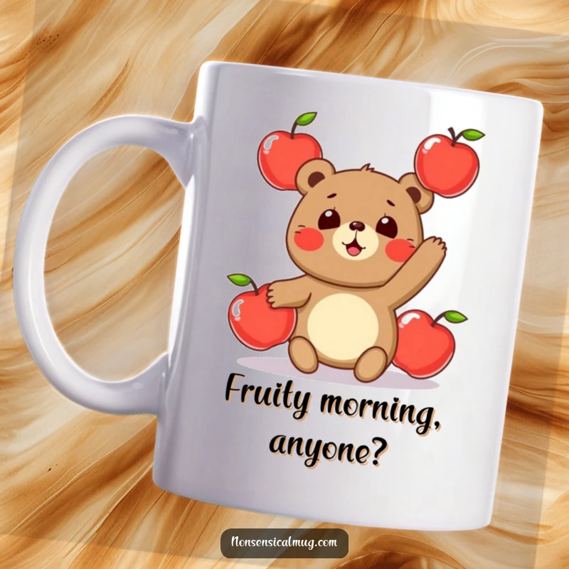 Funny mug showing a round, delighted bear character playfully juggling three bright red apples with a clumsy, cheerful expression.