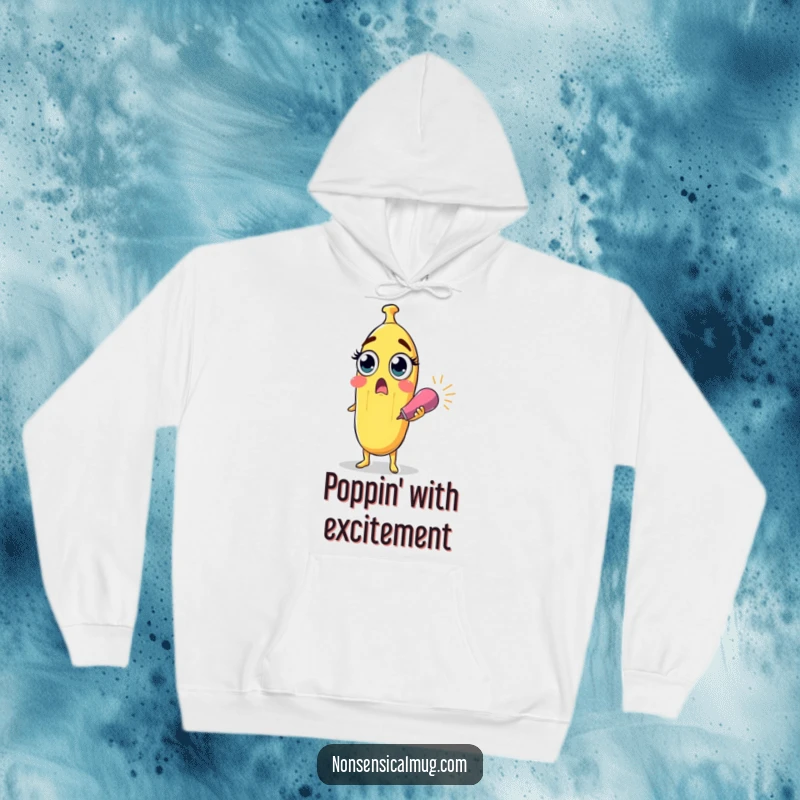 Funny surprised banana character with wide eyes holding a party popper on a soft hoodie, for cozy and surprising humor.